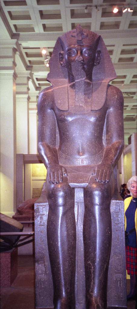 British Museum Top 20 19-1 Amenophis III Seated Statue 19. Amenophis III Seated Statue, Thebes Egypt, about 1400BC. In room 4 there are two 3m high seated statues in black granite of Amenophis III (also spelled Amenhotep). Amenhophis III was the first Egyptian King to be worshipped as a god in his own lifetime. Here is a full view of one of them